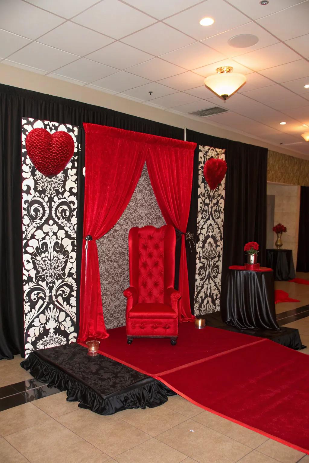 Create a dramatic scene with a monochrome backdrop accented with red for an elegant Valentine's Day photo booth.
